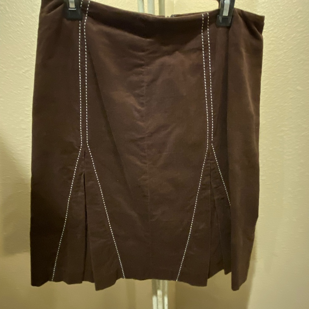 Corduroy like material with white stitching front and back.